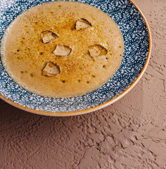 Gourmet creamy soup with truffle slices in decorative bowl