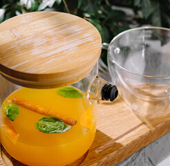 Refreshing orange detox water in glass pitcher