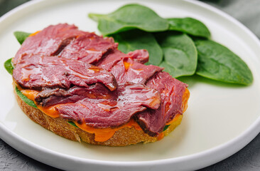 Gourmet beef tenderloin on toast with spinach