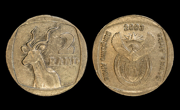 Detailed close-up of two South African 2 rand coins spread out on a black background.