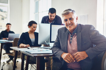 Mature man, portrait and happy in office with computer for research and product development for company with innovation. Business people, technology and online for problem solving and proposal.