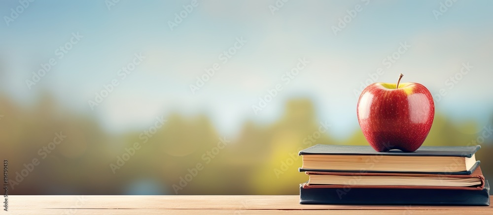 Poster an apple is resting on top of a stack of books creating a copy space image that symbolizes the conce