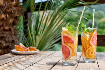 Summer refreshing lemonade drink with grapefruit, lemon, orange slices and mint. Fresh healthy cold...