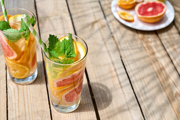 Summer refreshing lemonade drink with grapefruit, lemon, orange slices and mint. Fresh healthy cold...