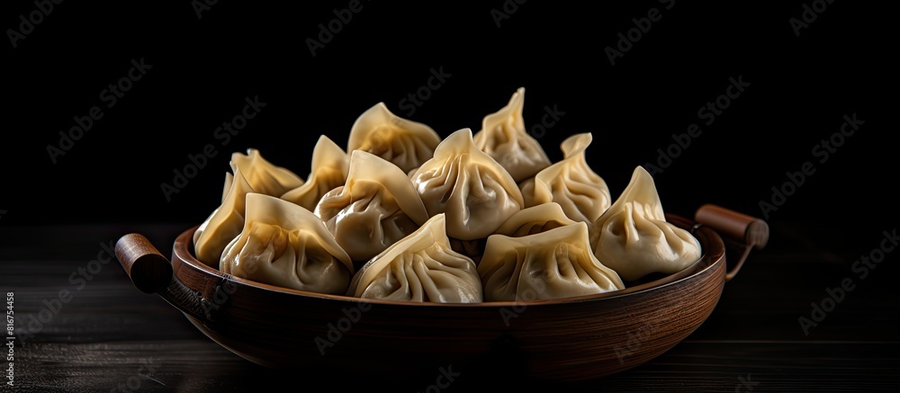Poster a delicious arrangement of dumplings on a black table perfect for adding text with the ample copy sp