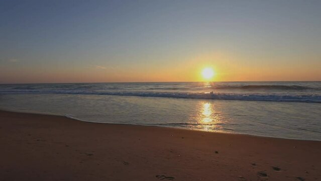 Scenic view of sun rising over the sandy beach of Bethany in Delaware, United States