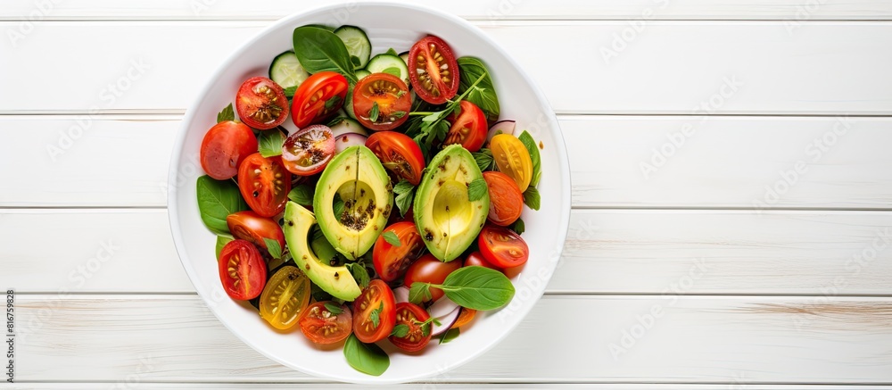 Aufkleber fresh avocado tomato salad in a bowl on a white wooden background top view flat lay overhead from ab