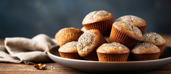 Close up view of healthy gluten free homemmade banana muffins with buckwheat flour Vegan muffins with poppy seeds on blue plate over gray wooden table Copy space