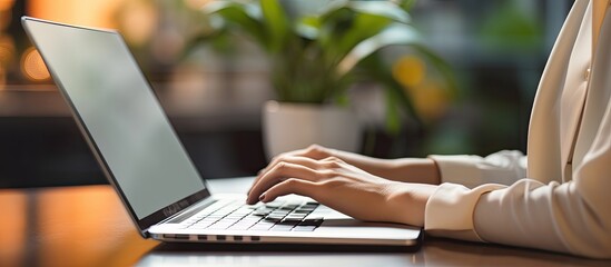 Close Up on Hands of a Female Specialist Working on Laptop Computer at Cozy office. copy space available