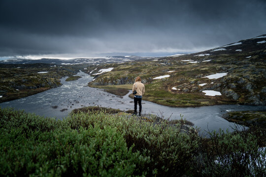 Camera Operator Overlooking Breathtaking Norwegian River System