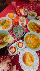 top view of Uzbek traditional dishes on a table with red tablecloth