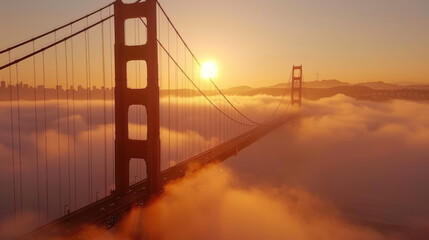 As dawn breaks over the bay, the Golden Gate Bridge emerges from the thick fog like a majestic...