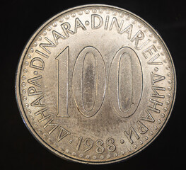 Closeup shot of a Yugoslavian dinar coin on a black background.