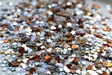 many small shiny sequins on a white background	