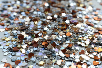 many small shiny sequins on a white background	