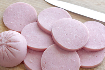 Sliced ham. Greek Parizaki pork sausage slices on chopping board. Very popular charcuterie products...