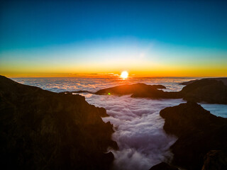 Do Arieiro, Madeira, Portugal. Sunset over the clouds, high mountains, walking over the clouds