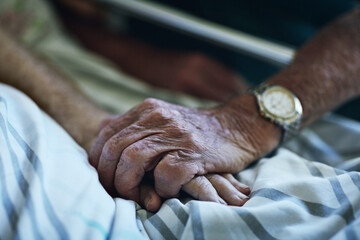 Senior people, holding hands and visit with hospital, closeup and elderly care or love together....