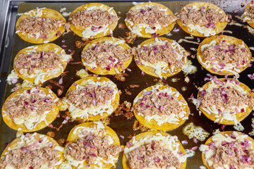 Frying tacos tortillas with cheese and meat on griddle in professional kitchen in restaurant. Mexican cuisine, Latin American fast food