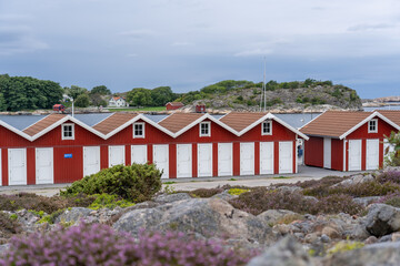 Scenic view of a group of traditional red and white houses in Munkkyrkan, Smoegen, Sweden
