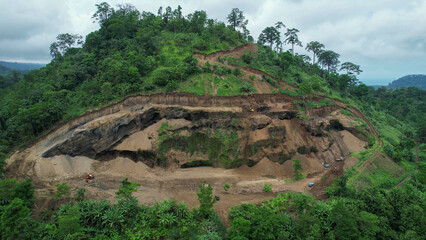 Aerial view of digger cleaning destruction of a jungle landslip