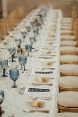 Formal dining table set up with white plates and silverware