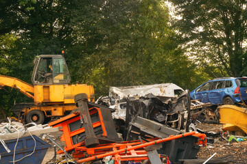 Old petrol car being demolished in metal recycling scrap yard