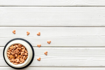 Bowl of biscuits for pets - food in a shape of heart, top view