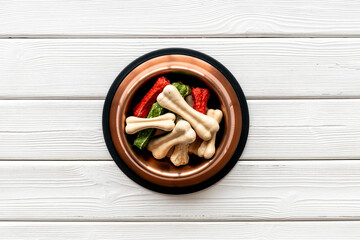 Food and treats for pets. Bowl full of dog chew bones