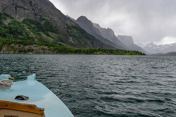 The bow of the boat, bowspirit and rigging, rope, foredeck on St Mary Lake with Citadel Mt. Little...