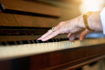 Home, hands and old woman with piano, sound or instrument with talent, music or training for performance. Closeup, classical artist or senior person with culture, audio or practice with hobby or jazz