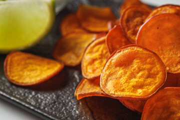 sweet potato chips on a dark wooden rustic background