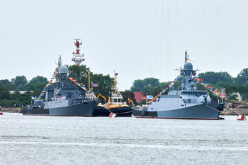 Military parade of Russian naval forces warships along coastline, seafaring tradition of military...