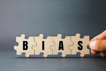 wooden puzzle with the word BIAS. inclination or prejudice for or against one person