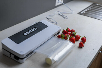 on the kitchen table vacuum machine and strawberries