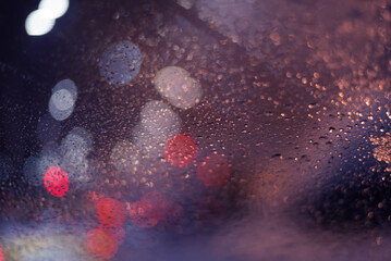 Blurred background with raindrops and lights.