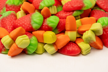 Assorted colorful gummy candies isolated on a white background.