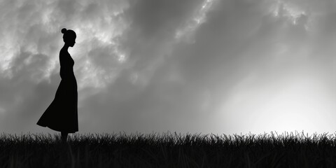 The black and white photo shows a lonely woman standing in a field of wheat. The sky is cloudy and there is a sense of sadness and isolation in the image.