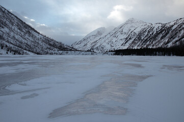 Snow-covered winter mountain lake, Russia, Siberia, Altai mountains.
