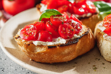 delicious Italian bruschetta with tomatoes on a light stone background