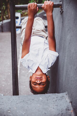 boy hanging upside down on his hands