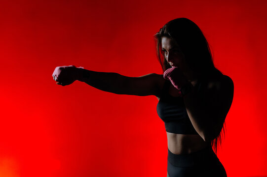 close-up, fist of a female boxing, martial arts athlete. Woman boxer with pink bandages for boxing