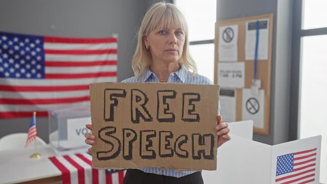 A serious woman holding a 'free speech' sign in a voting room with american flags