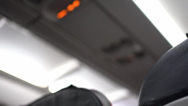Selective focus on the ceiling of the aircraft where safety features such as an oxygen mask are located. High quality 4k footage