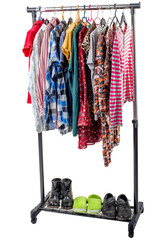 Different clothes and shoes from the wardrobe on the isolated rack