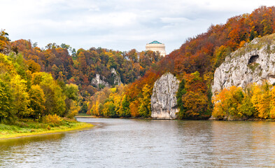 Autumn panorama with colorful foliage Donau river and “Hall of Liberation“ monument in Kelheim,...