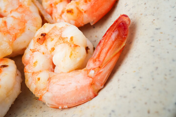 Close up photo of Grilled shrimp without skin served on a small plate and placed on the wooden table. Concept for whole natural protein and omega-3.