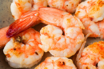 Close up photo of Grilled shrimp without skin served on a small plate and placed on the wooden table. Concept for whole natural protein and omega-3.