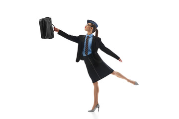 Elegant stewardess in business suit, balancing on foot, holding briefcase, showing grace and...