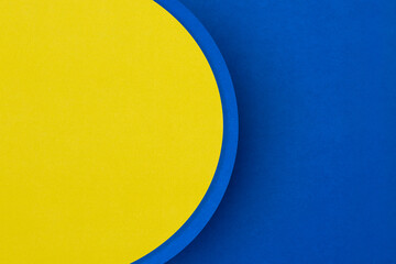 Bright yellow and blue textured paper surface with semi circle background